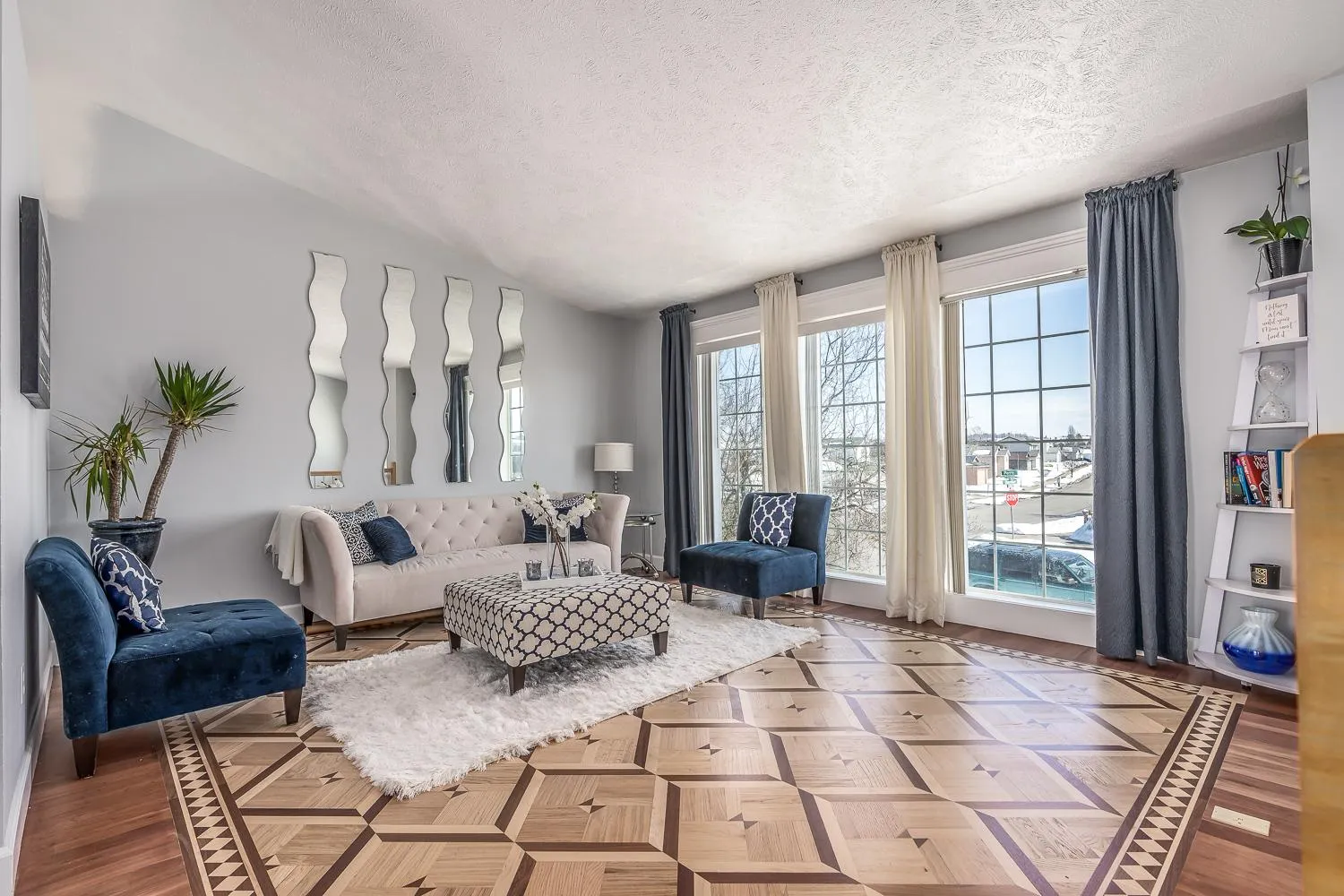 Living room with a custom parquet pattern floor in solid hardwood
