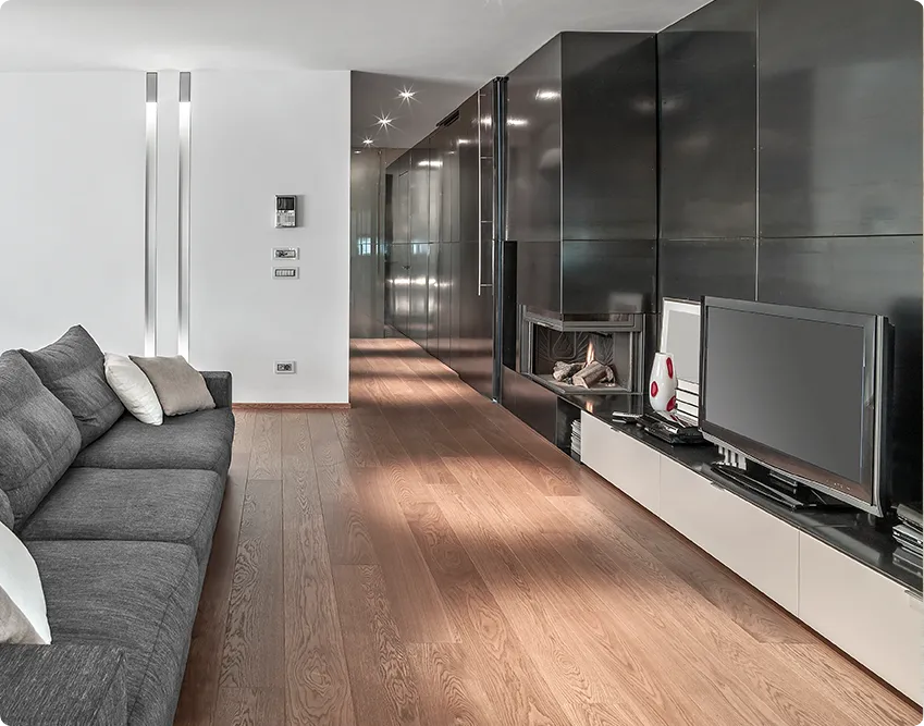 Modern living room with a media wall, fireplace and warm laminate wood flooring