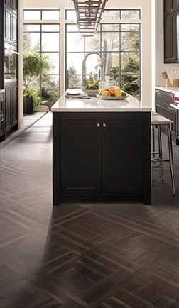 Herringbone parquet floor in a kitchen with dark cabinetry and tall windows