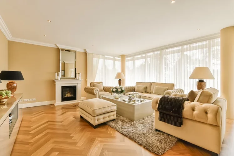Living room with a fireplace and warm hardwood flooring