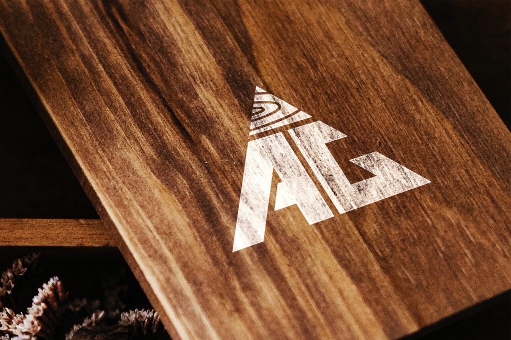 AG Floor Covering logo on a polished walnut board