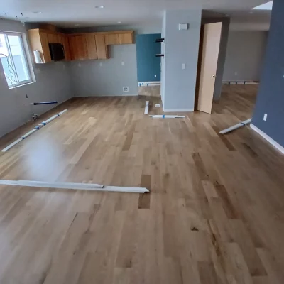 Open-plan room during white oak hardwood installation