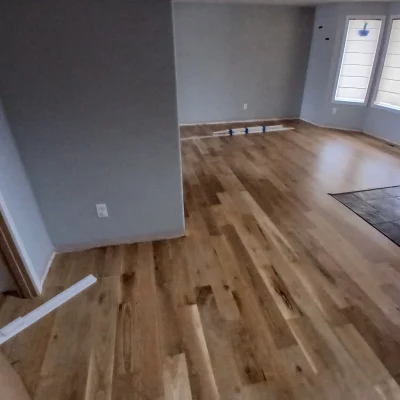 Refinished white oak hardwood floor in a room with plantation shutters