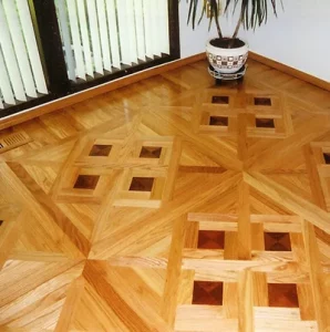 Custom geometric parquet floor with diamond mosaic inlays in mixed wood tones by AG Floor Covering