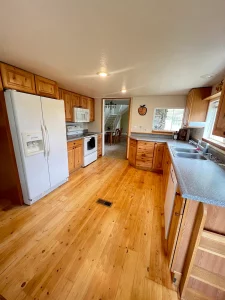 Kitchen with warm knotty-pine plank flooring by AG Floor Covering