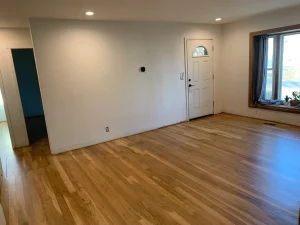 The same living room after AG Floor Covering refinished the floors to bright white oak