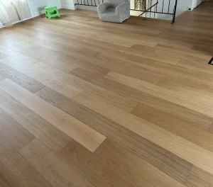 Light engineered oak hardwood floor in an open living area, installed by AG Floor Covering