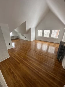 Vaulted-ceiling room with glossy refinished hardwood flooring in a Spokane rental unit