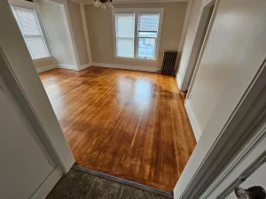 Refinished hardwood flooring meeting tile at a doorway in a Spokane rental unit